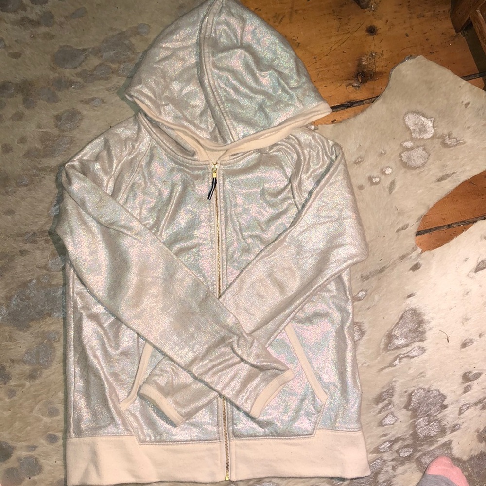 a holographic sip up sweater